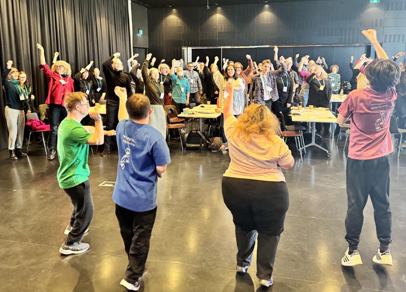 Members of Jolt dance and warm up with forum participants